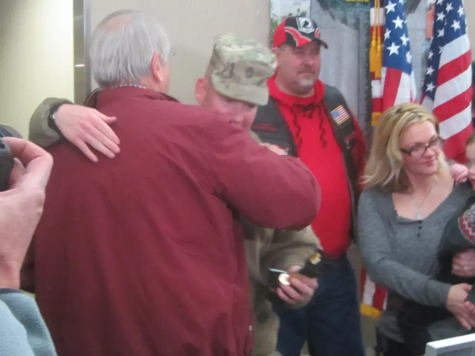 Rochester Mayor Brede & SGT Delaney embrace at RST - - photo: Steve Richards - TSM - Rochester, MN